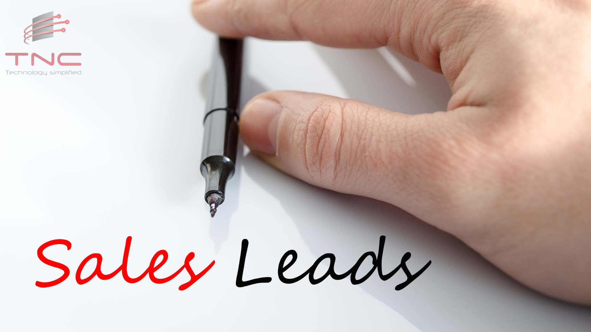 a hand holding a pen, they wrote sales leads below